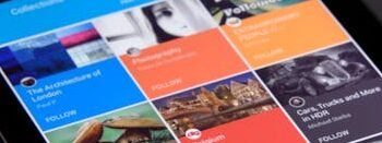 Close-up of a tablet displaying diverse content collections in a grid format.