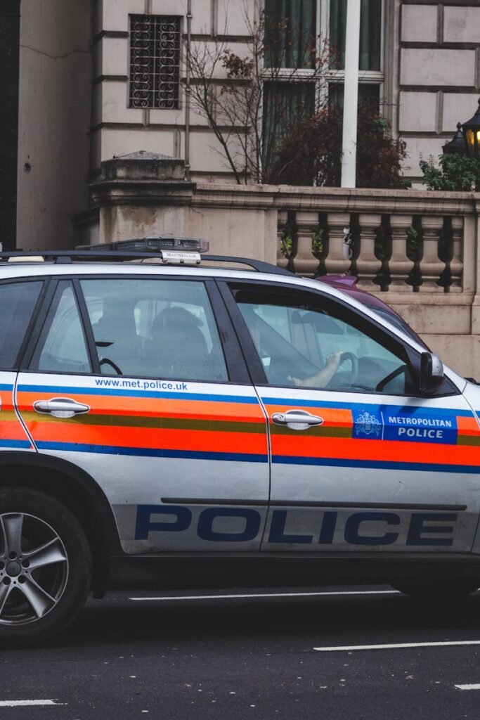 Police vehicle parked on an urban street outside a London building